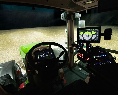 Fendt 800 Vario Gen5 tractor in a field at night, in the cab, showing the controls