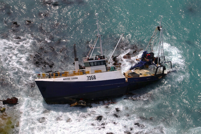 The Austro Carina was stranded at the base of a tall cliff face.