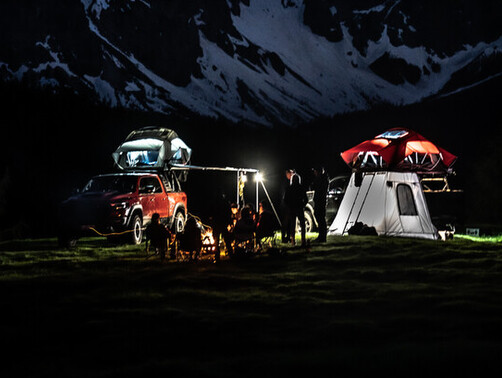 Yakima Skyrise Rooftop tents with Annex set up in the mountains at nighttime