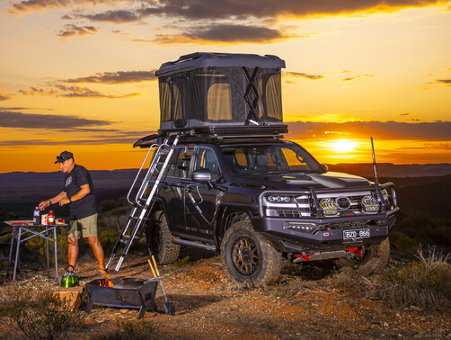 ARB Rooftop tent set up on top of vehicle at sunrise