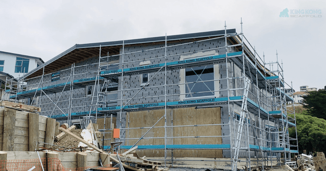 Scaffolding with 'King Kong Scaffold' text surrounds a building under construction in Wellington.