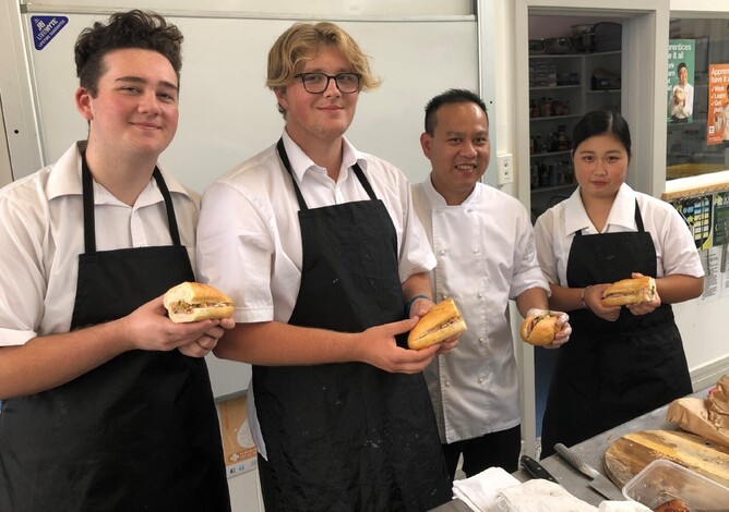 Tamatea High School students Tai Dawson, Leyland McLeod and Mone Takanashi with Bahn Mi Saigon Chef Cong Dinh.