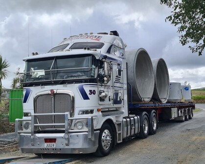 Photo of Mackenzie Transport truck transporting large concrete structures for civil construction project
