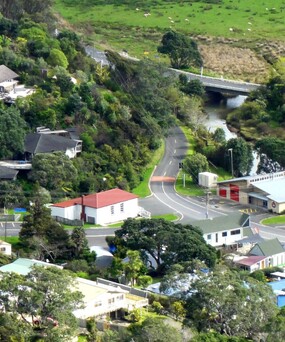 Aerial view of the Kuaotunu Hall and the Kuaotunu Fire Station and the junction with SH25 on the Coromandel Peninsula