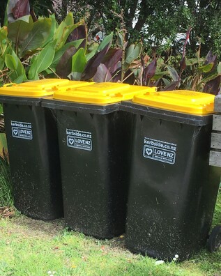 Three TCDC recycling bins left on the kerbside in Kuaotunu on the Coromandel Peninsula