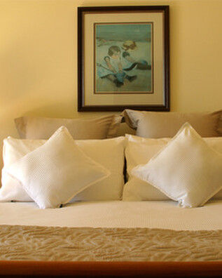 A double bed made up with pillows at Kuaotunu Bay Lodge on the Coromandel Peninsula
