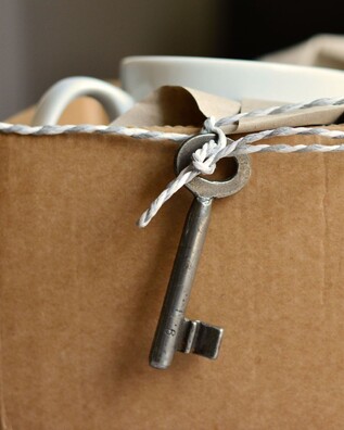 A packing box with a key hanging from a piece of string