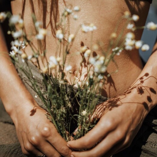 llustration of a woman holding her lower belly, symbolizing womb healing and feminine energy.