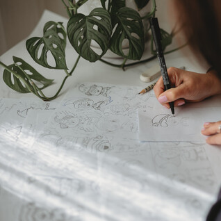 Image of Kelly drawing Christmas elves. Creative Box. Design studio in Kihikihi, Te Awamutu. New Zealand.