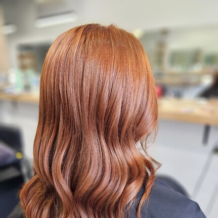 A rich wavy copper hair colour and style by Hair by Shiyee.