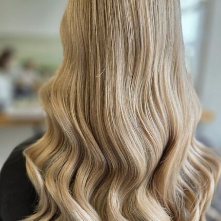 A beautiful wavy golden blonde colour by Hair by Shiyee.