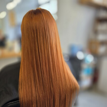 A long, straight copper hair colour by Hair by Shiyee.
