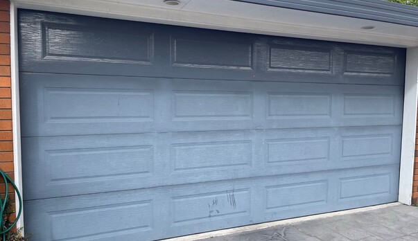 Is your garage door looking tired, chalky, and discoloured?
