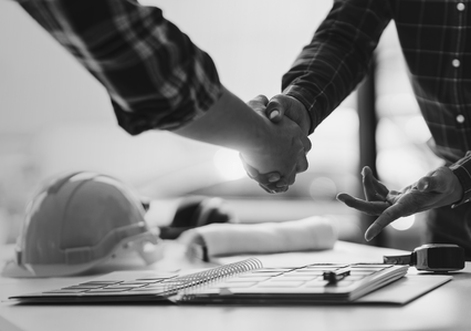 two men shaking hands, cropped so you can only see the arms