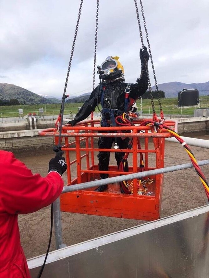 THis photogrpahs shows our dive team member getting ready to dive into a Waste Water Treatment Plant.  Contamination diving is very specific and requires vaccinations and a special skill set.  The diver is fully enclosed int he contamination suit and often the biggest battle is with their mind.  This job was to check on the valves in the WWTP and report back to the client.