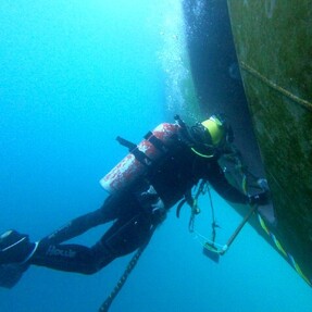 Diver working on vessel offshore
