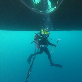 Diver working on vessel offshore