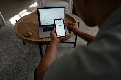 Tradie checking invoices and GST on laptop