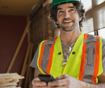 Tradie using phone to share work photos on social media