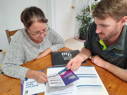 Builder discussing plans with homeowner