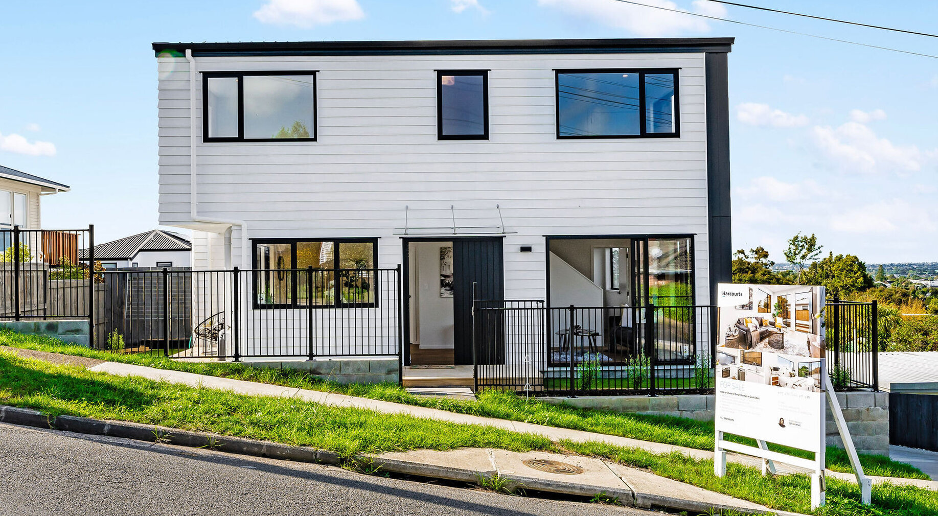 Image of the street frontage of a residential new build townhouses on Roland Hill, Glen Eden, Auckland. Built by Auckland builders, Eden Construction. New Zealand.