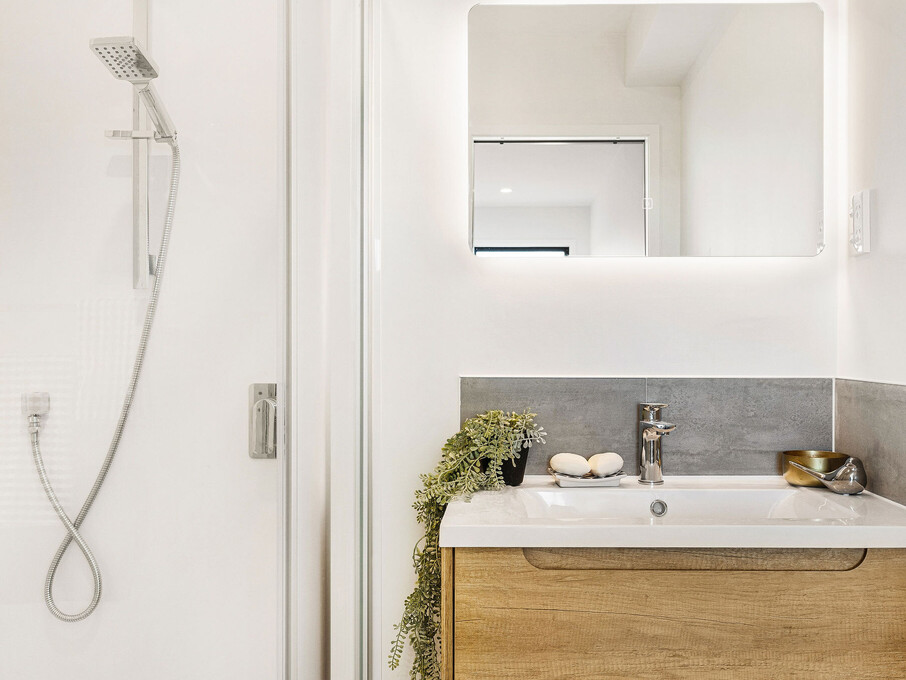 Image of the bathroom with single vanity inside the residential new build townhouses on Roland Hill, Glen Eden, Auckland. Built by Auckland builders, Eden Construction. New Zealand.
