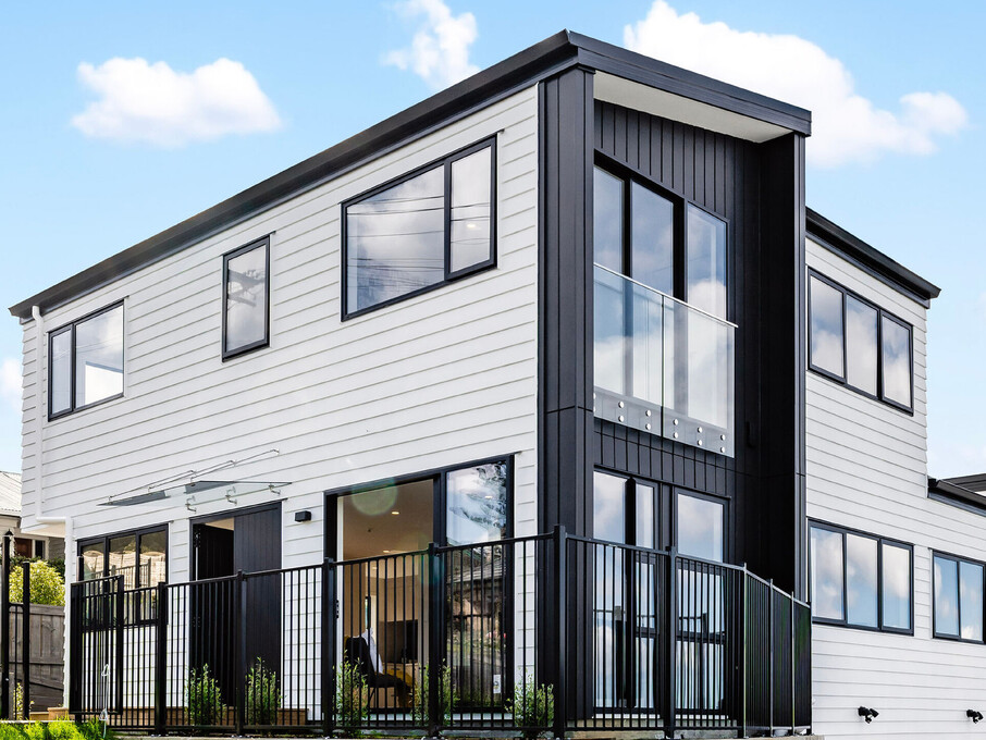 Image of the street frontage of a residential new build townhouses on Roland Hill, Glen Eden, Auckland. Built by Auckland builders, Eden Construction. New Zealand.