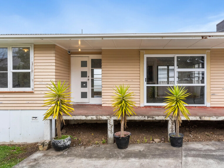 Image of a residential home renovation. Photo of exterior and landscape before renovation.