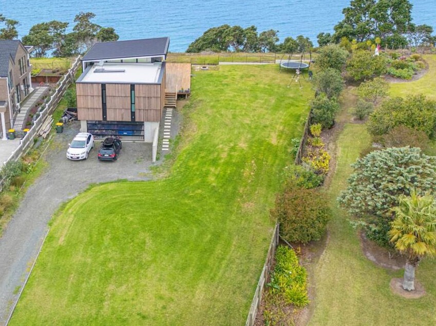 Image of a residential home renovation. Photo of exterior and landscape before renovation.