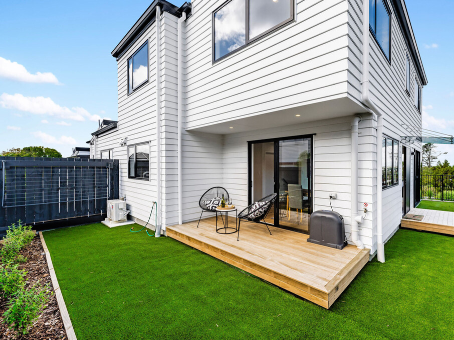 Image of the backyard and decking of a residential new build townhouses on Roland Hill, Glen Eden, Auckland. Built by Auckland builders, Eden Construction. New Zealand.