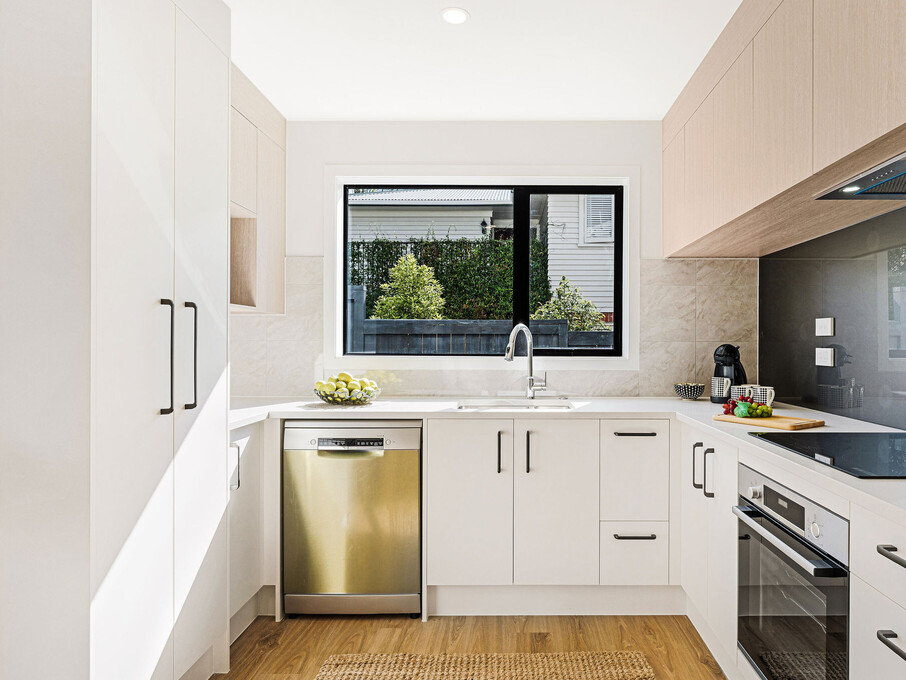 Image of the kitchen inside the residential new build townhouses on Roland Hill, Glen Eden, Auckland. Built by Auckland builders, Eden Construction. New Zealand.
