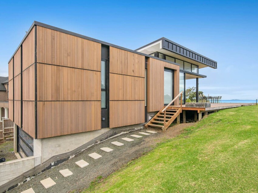 Image of a residential home renovation. Photo of exterior and landscape before renovation.