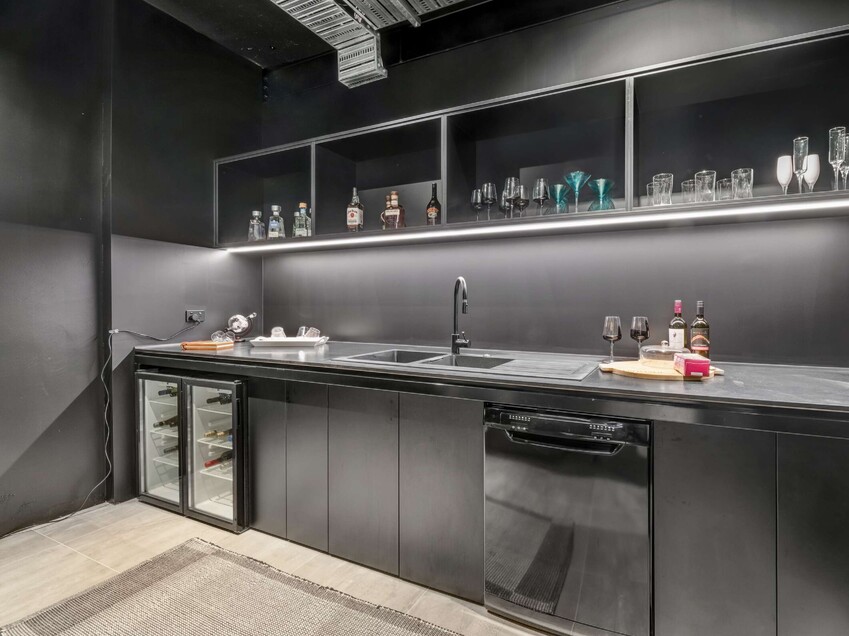 Image of a residential home renovation. Newly remodelled butlers kitchen in black by Auckland builders, Eden Construction. New Zealand.