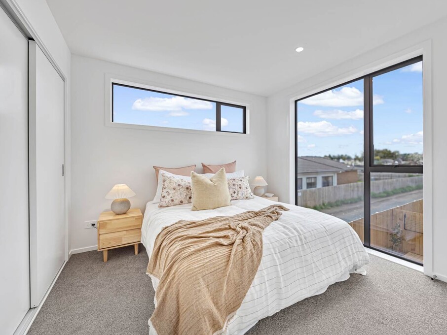 Image of modern bedroom inside one of six architecturally designed family townhouses on Tapu Road, Huapai, Auckland. Built by Auckland builders, Eden Construction. New Zealand.