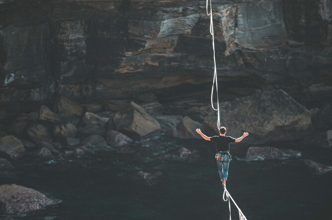 Man balancing on tight rope to show privacy being balanced