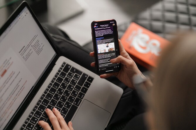 Sending emails on laptop/phone to show Belle PR emailing tips