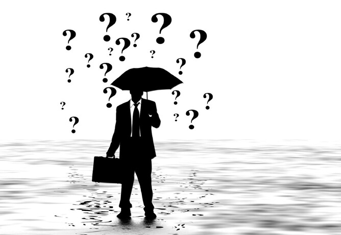 Question marks falling on umbrella as questions asked