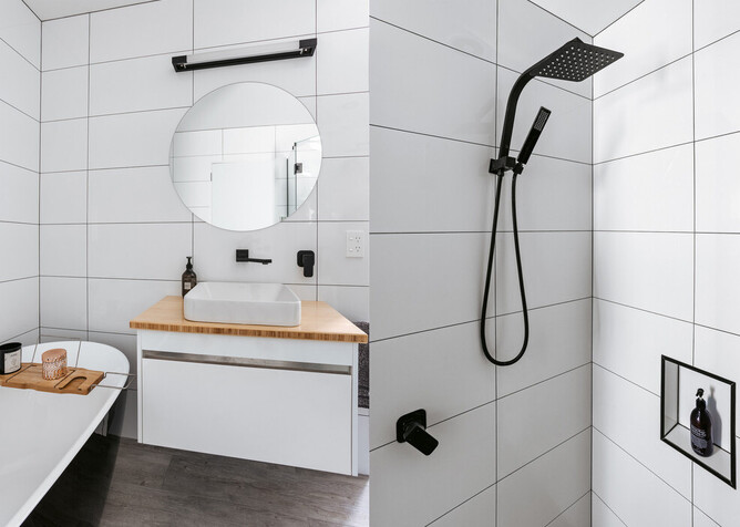 White tiled bathroom with black tapware and bathroom fittings