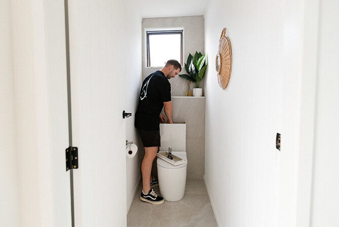 Plumber fixing a toilet leak