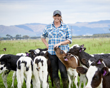 Craig Brown Photographer's image of a female farmer in a paddock with calves