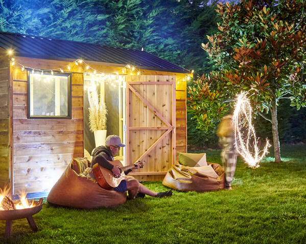 Craig Brown Photographer's image of a shed at nighttime with family playing guitar and dancing with sparklers