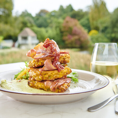 Craig Brown Photographer's studio shot of a corn fritters and bacon with a glass of wine