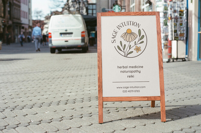 Image for 5 signs you need a rebrand blog. Image of Sage Intuition sandwich board. Cream with floral circular logo.