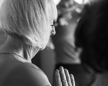 A women practicing Hatha Yoga in a class