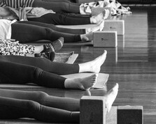 Yoga students lying in Savasana (Corpse Pose)