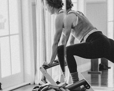 A women practicing Reformer Pilates