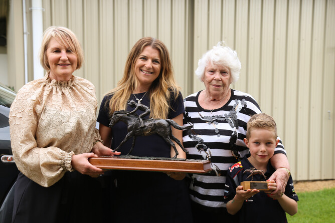 NZTBA CEO Justine Sclater and Cathay Pacific Corporate Account Manager Heather Skinner present Marie Leicester and grandson Charlie with the trophy for the Seton Otway New Zealand Horse of the Year. Photo: Picket Fence