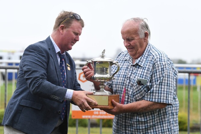 Owner/Breeder Aidan Schumacher receives the Marton Cup trophy following Canheroc's win in the Listed event on Saturday. - Photo: Race Images