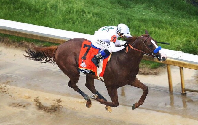 Justify racing in the famous Winstar Farm silks