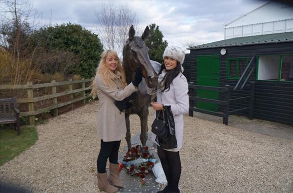Holly and her Aussie flatmate Kara (pictured above) with a statue of jumps legend and three times Cheltenham Gold Cup winner Best Mate.